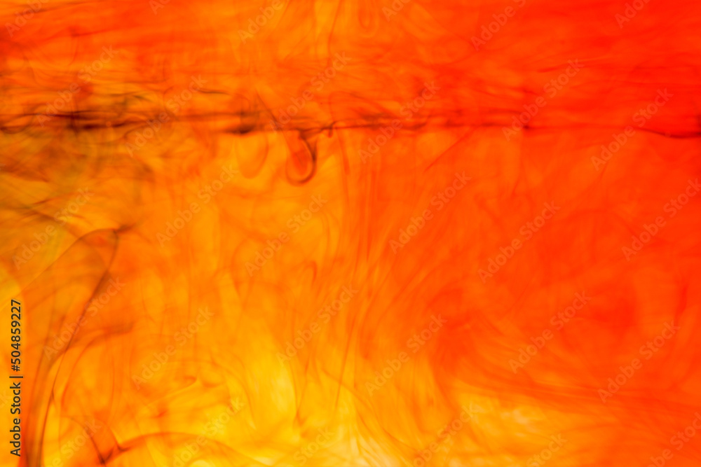 Poster abstract soft focus orange color ink floating in water for backdrop use.
