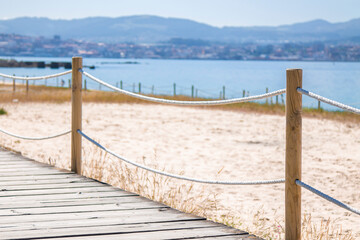 Fototapeta na wymiar wooden walkway with beach in the background. holiday landscape