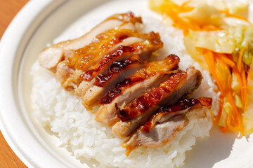 Spicy Grilled Chicken
 with rice on white natural paper plate