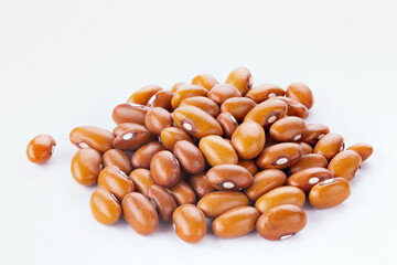 Dried orange beans on a white plate.
