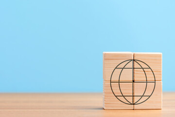 Wooden cubes on blue background with icon of globe earth world international network planet worldwide, concept