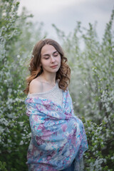 Photo of a beautiful young girl in a spring garden.