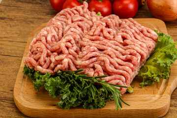 Raw pork minced meat over board