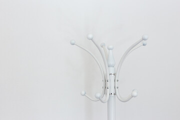 Floor hanger for white clothes on a white background