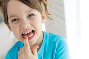 The kid lost a tooth. Baby without a tooth. Portrait of a little girl no tooth. High quality photo