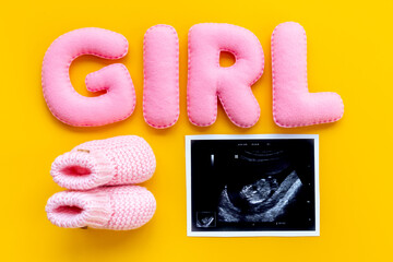 Ultrasound scan of unborn baby with letters girl