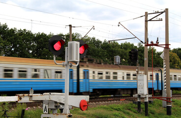Train Car Passes A Closed Barrier At A Railway Crossing
