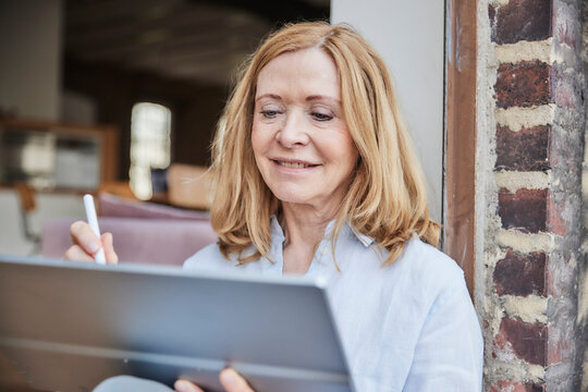 Smiling businesswoman using tablet PC