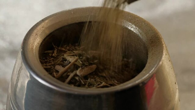 Close-up of yerba mate  pouring into a cup