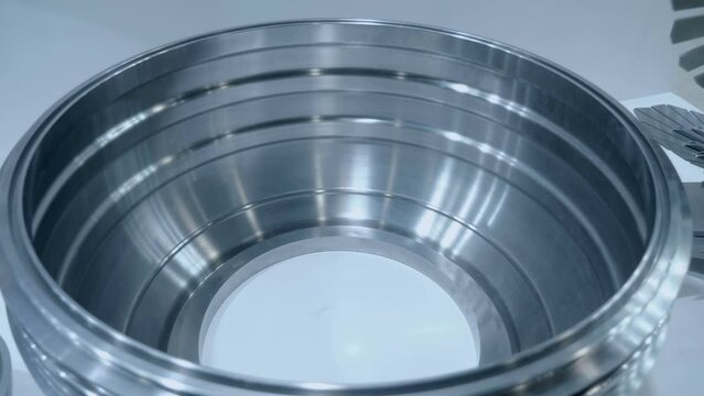Stainless steel part after high-quality processing on a turning and milling machine is used in industrial production. Close up. Shot in motion