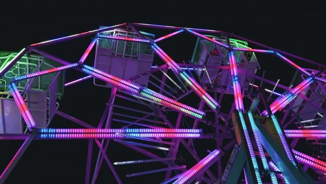 Ferris wheel at night of colorful with outdoor round rotation st Amusement Park, The annual temple event has activities, neon light