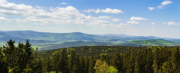 Fototapeta na wymiar Aerial view to sumava hills with blue sky from lookout tower Klet. Czech spring landscape