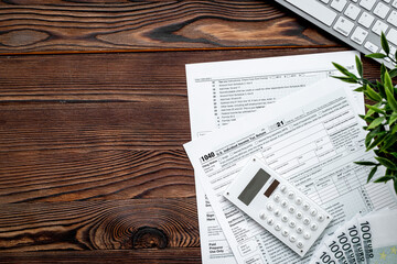 Accountant culculate taxes - US tax form on office table desktop
