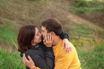 Young couple kissing on grassland