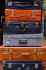 row of old vintage suitcases on a wooden background, retro style travel