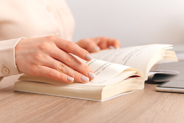 Cropped photo of woman hand holding a book.
