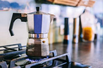 Stovetop espresso coffee maker on kitchen gas stove - obrazy, fototapety, plakaty