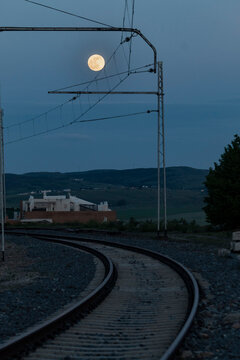 Full moon over the catenary suspension near the Ávila Railway station
