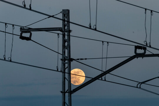 Full moon over the catenary suspension near the Ávila Railway station
