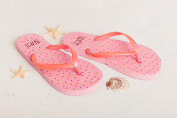 Beach accessories. Flip flops and starfish on colored background. Top view Mock up with copy space