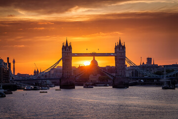 Beautiful sunset view of the Tower Bridge of London, United Kingdom, lifted up with passing by...