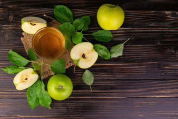 Apple juice and green apples on a wooden background.Flat lay.Copy space.