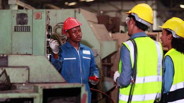 Slow motion Training trainee concept. Caucasian male engineer explain the procedure for using the correct metal robot machine at lathe industrial factory.