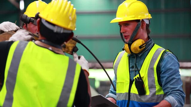 Slow motion Training trainee concept. Caucasian male engineer explain the procedure for using the correct metal robot machine at lathe industrial factory.