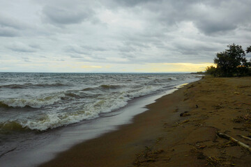 Golden sunset against waves at  Matema Beach, Lake Nyasa, Tanzania