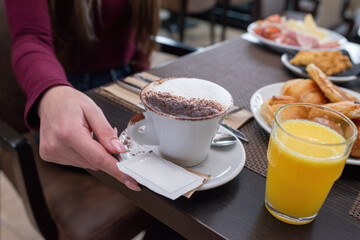 Breakfast with cappuccino, sweets and orange juice