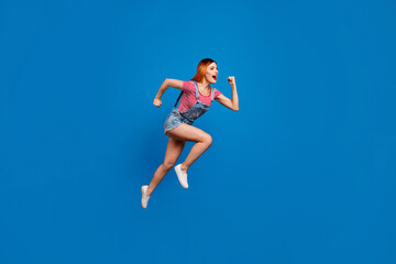 Full body portrait of energetic active person look empty space jump hurry fast isolated on blue color background
