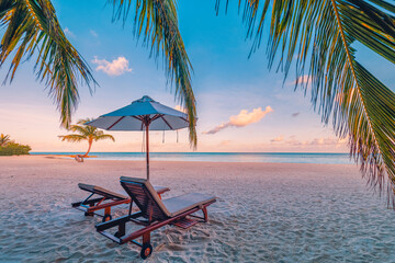 Couple travel background, luxury resort beach with chairs and umbrella. Sunset landscape, coast sea...