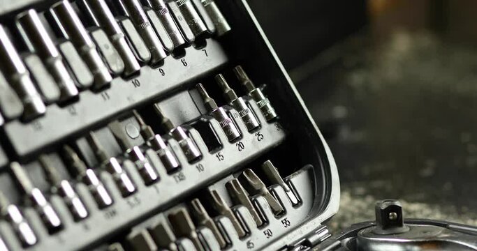 Man hand take working tools from set box with different types of metal steel heads and bits at the workshop, Interchangeable screwdriver set.