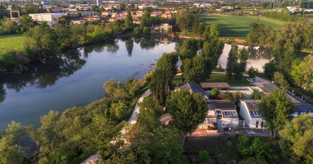 Aerial view of the River Sile and of the "Greenway del Sile" bike and walking trail, on the foreground the "PArCo Foundation",on the background the historical Villa Barbaro bed and breakfast