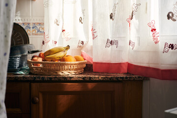 Fruit bowl illuminated by the morning light in the kitchen