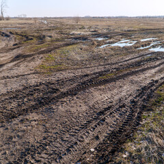 Spring landscape. Dirty spring road. Impassability and mudslides.