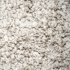 The wall is covered with gray decorative plaster