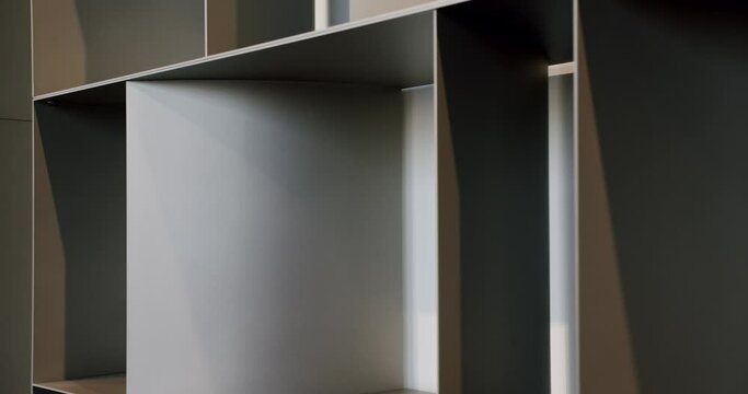 Home modern black shelf. Nice designed modern interior of the living room furniture. Shelves with home stuff. Indoor minimalist furniture. Minimalist brown shelf, Modern Furniture and cozy design.