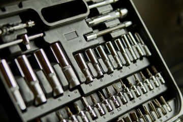 Open set box with working tools different types of metal steel heads and bits at the workshop, Interchangeable screwdriver set.