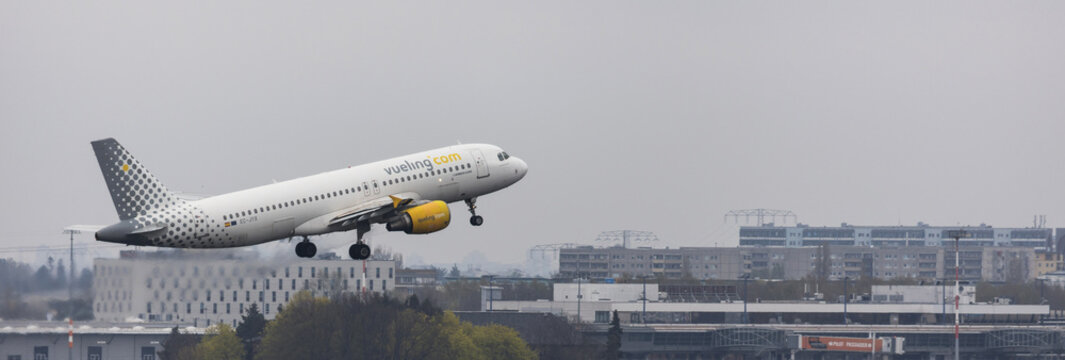 berlin,berlin /germany - 24 04 2022: a vueling airplane over the cityscape of berlin panorama