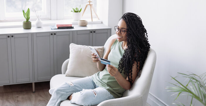 Woman holding credit card and using smartphone at home panoramic banner, businesswoman shopping online, e-commerce, internet banking, spending money, working from home concept