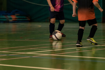 two children indoor football players game in the regional championship