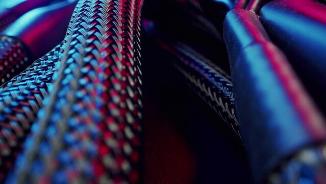 Close-up power supply connection cables to computer motherboard wrapped in mesh material. High quality 4k footage