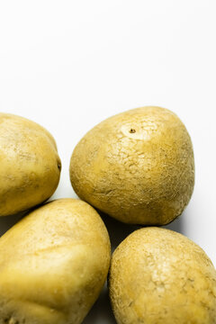 Close up view of potatoes on white background.