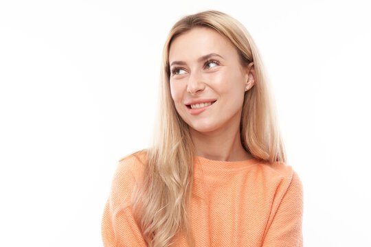 Smart blonde girl in casual grimacing and biting her lips thinks doubts, makes decision isolated on white studio background
