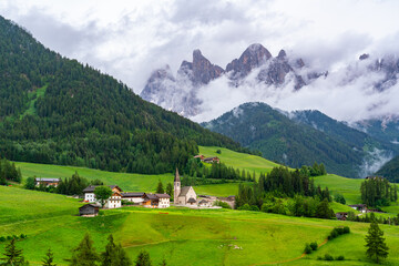Fototapeta na wymiar Evening view the famous Church of St. Magdalena with Odle Peaks of the Italian Dolomites Mountain in Province of Bolzano, South Tyrol, Italy.