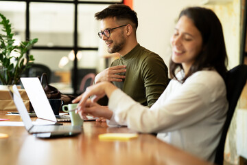 Colleagues in office. Businesswoman and businessman discussing work in office..