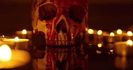 Blood stained skull against dark background closeup