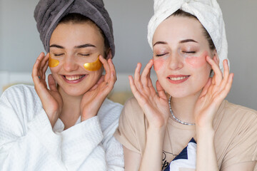 Two girlfriends make face masks at home. Preparing for a hen party. Preparing for the celebration....