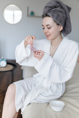 The girl is engaged in a beauty procedure at home. Time for yourself. Taking care of yourself. Girl makes a face mask at home. Skin care at home. Teen skin care.